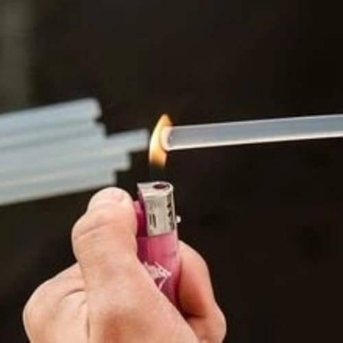 DIY Hot Melt 7mm Glue Stick - being held by a hand and heated by the flame of a pink lighter.