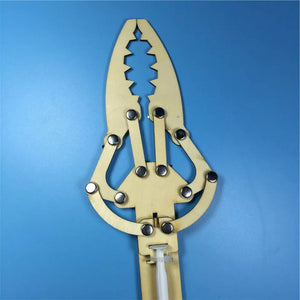 DIY Hydraulic Manipulator Wooden STEM Kit Unassembled - a close-up of the assembled light-wood claw mechanism with silver rivets on a blue background.