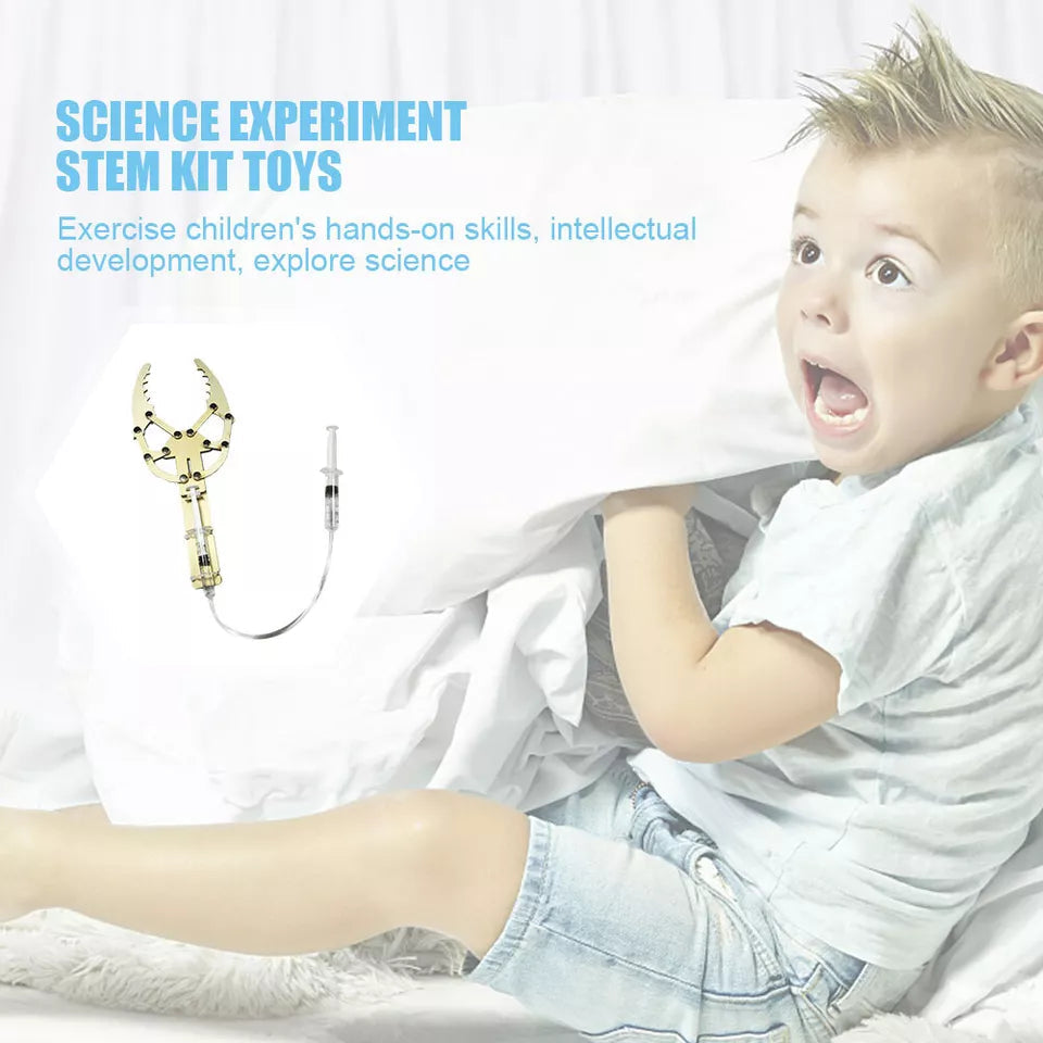 DIY Hydraulic Manipulator Wooden STEM Kit Unassembled - a light-wood claw mechanism connected by a clear tube to a syringe control.