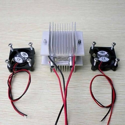 DIY Kits Thermoelectric Peltier Refrigeration Cooling System Water Cooling+ Fan+ 2pcs TEC1-12706 Coolers - a central aluminum heat sink with two water tubes and two black cooling fans.