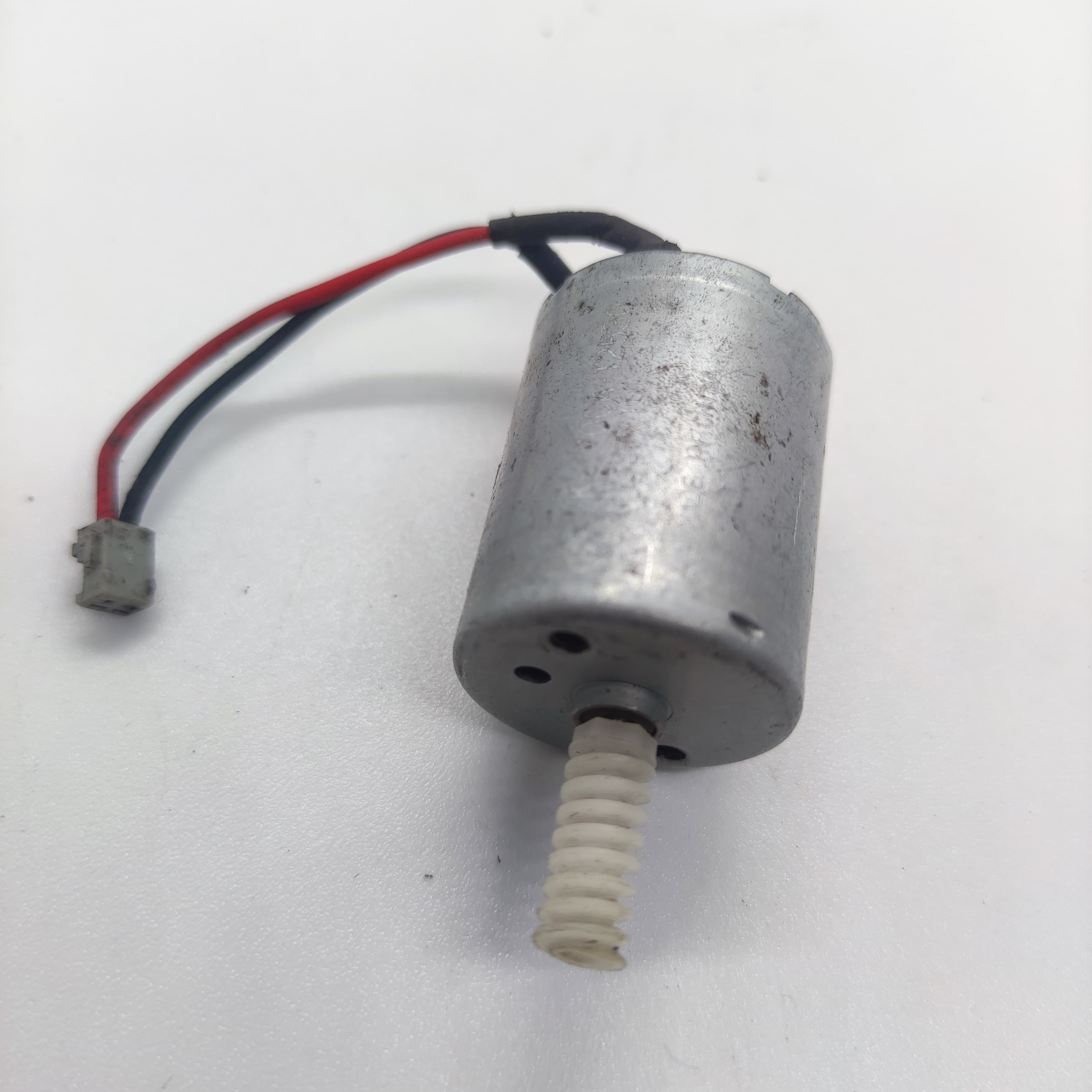 DIY Mini 5vdc DC Motor - shown as a silver cylindrical motor with a white plastic worm gear on the shaft and a red and black wire with a small connector.