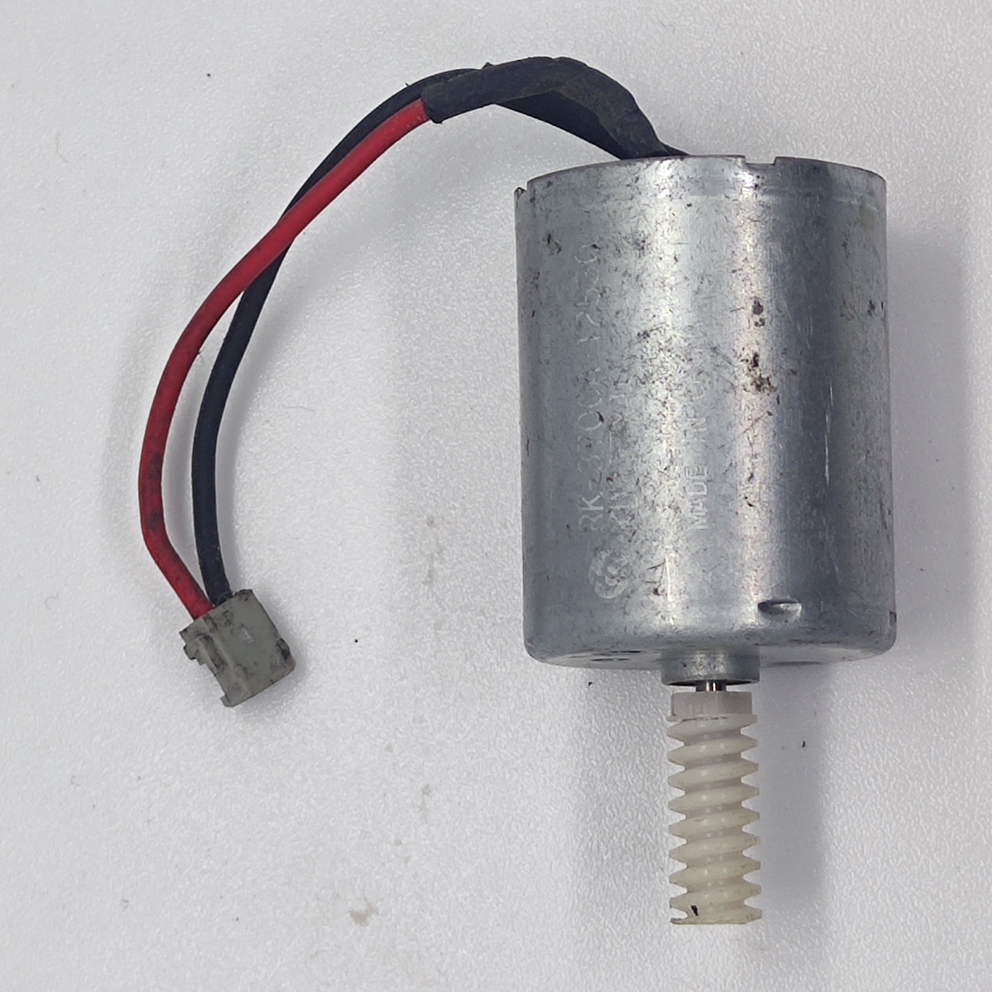 DIY Mini 5vdc DC Motor - shown with a silver cylindrical body, a white plastic worm gear on the shaft, and a red and black wire with a small connector.