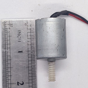 DIY Mini 5vdc DC Motor - shown next to a metal ruler for scale, featuring a cylindrical silver motor body with a white plastic worm gear on the shaft.