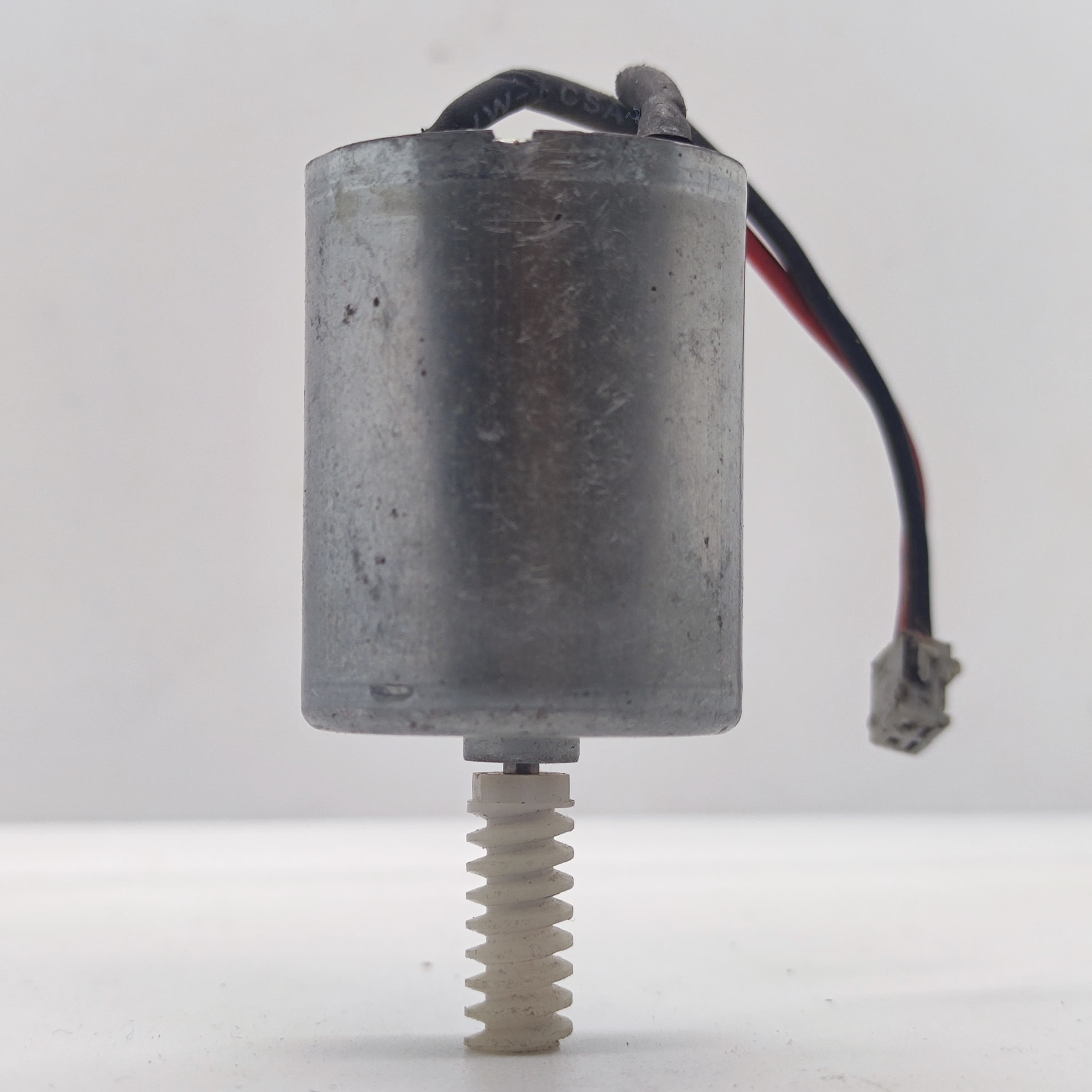DIY Mini 5vdc DC Motor - shown as a silver cylindrical motor with a white plastic worm gear on the shaft and a short black and red wire with a connector.