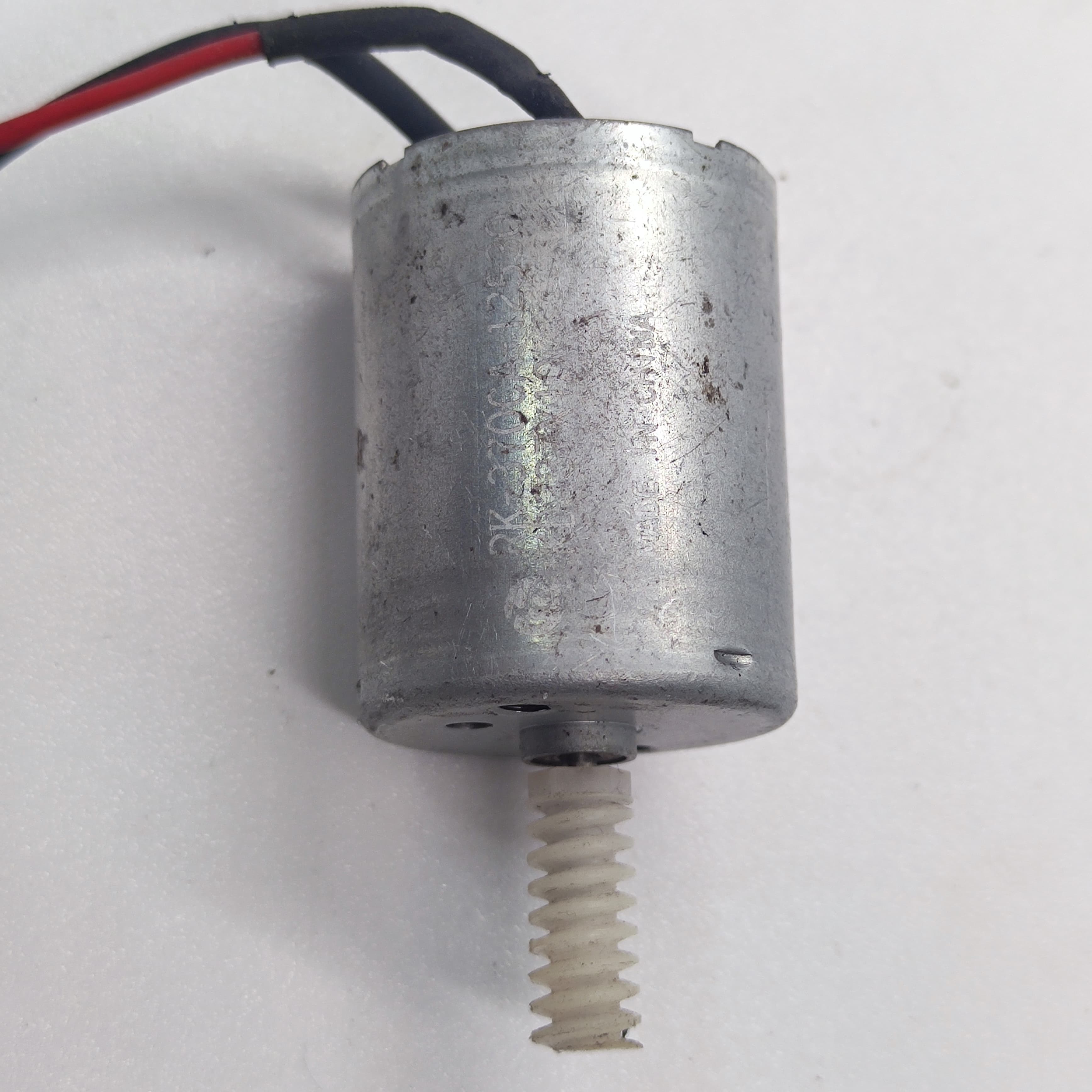 DIY Mini 5vdc DC Motor - shown as a silver cylindrical motor with a white plastic worm gear attached to the shaft and two connected power wires.