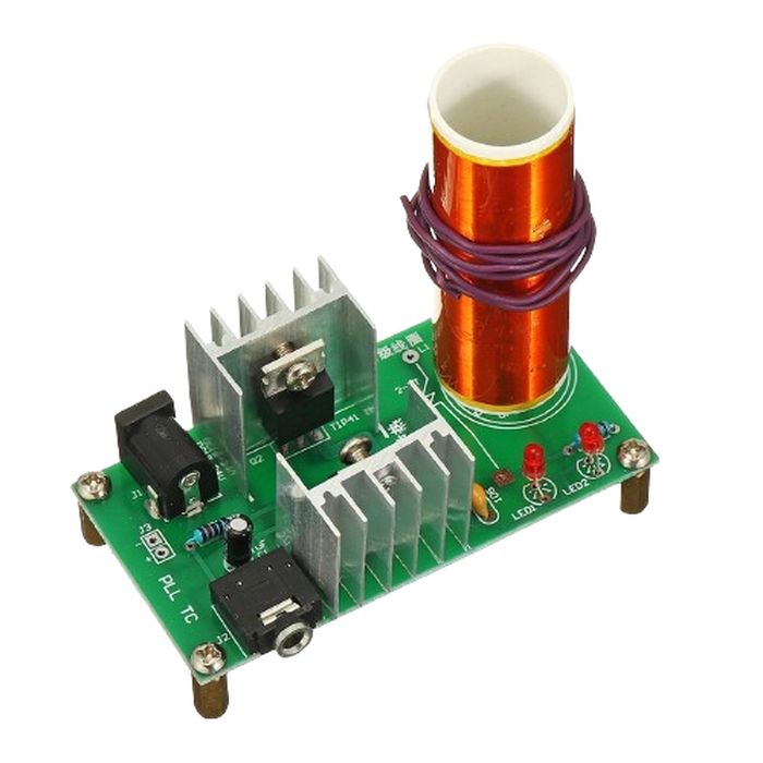 DIY Mini Tesla Coil Plasma Speaker Kit Unassembled - a green circuit board with a copper coil, two heat sinks, a power jack, and an audio port.