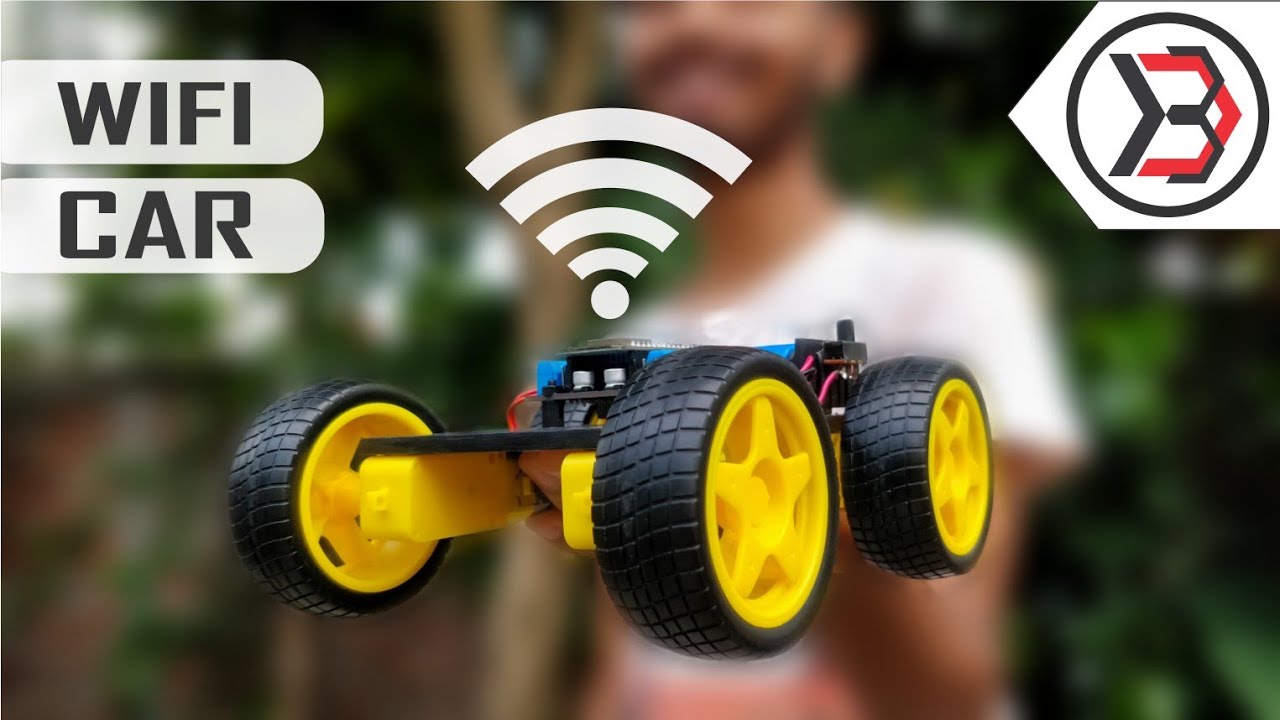 DIY Simple WiFi Controlled Robot Car Parts Not Pre Assembled - shown as a partially assembled yellow-wheeled robot chassis held against a blurred background.