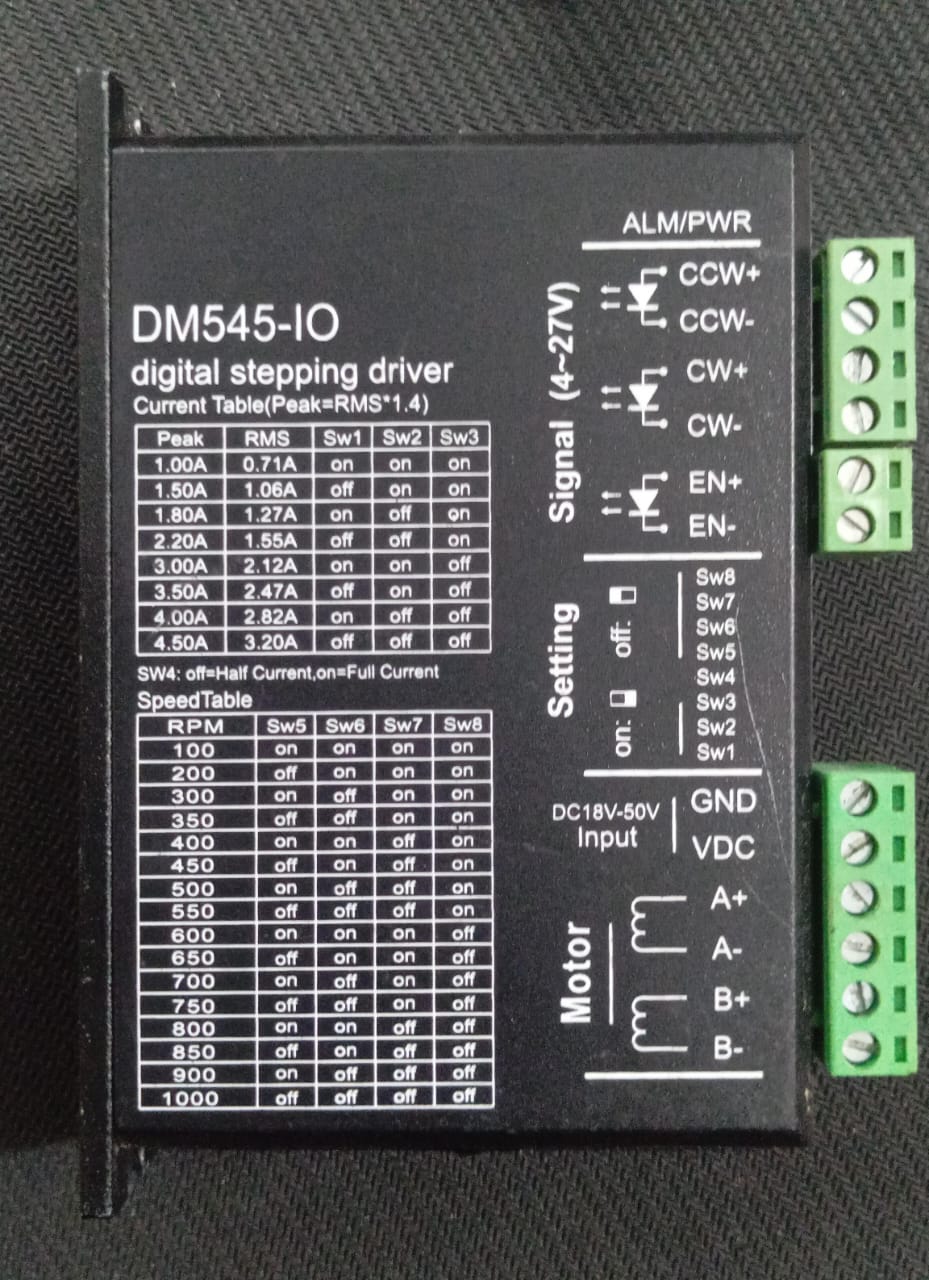 DM545-IO 18-50V/DC 4.5A 2-phase Stepper Motor Driver - a black rectangular module featuring a printed current and speed configuration table, side terminal blocks, and DIP switches.