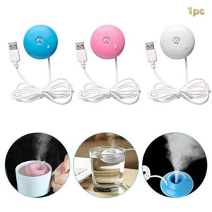 Donuts Shape Mini USB Humidifier Mist Maker Air Diffuser - pink, and white with USB cables, shown floating in cups of water producing mist.