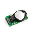 DS1302 Avr Real Time Clock Module With Cell - green circuit board, silver crystal oscillator, black chip, and a CR2032 battery in a black holder.