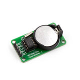 DS1302 Avr Real Time Clock Module With Cell - green circuit board, silver crystal oscillator, black chip, and a CR2032 battery in a black holder.