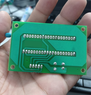 DS30F2010 Programming Socket For Pickit 3 Pickit 2 - the underside of the green rectangular circuit board with exposed soldered pins and traces.