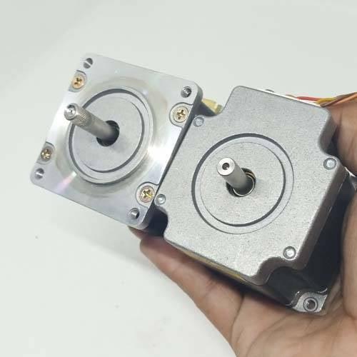 Dual Shaft NEMA 23 2A Stepper Motor For CNC 3d Printer - shown as a close-up of two silver-toned metal stepper motors held in a hand.