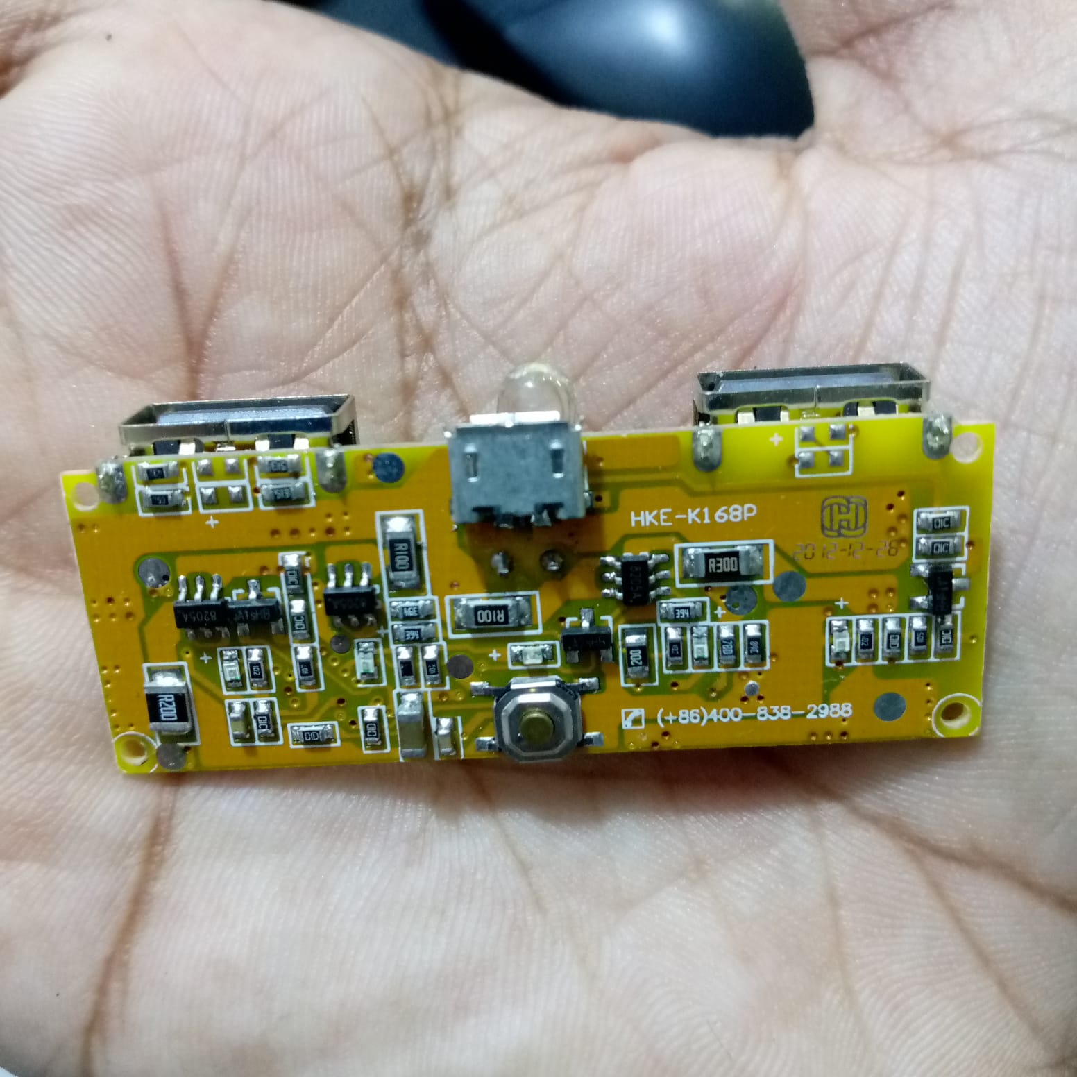 Dual USB 18650 Battery Charger Power Bank Module 5V 1A 2A - a yellow rectangular circuit board with two USB ports, a micro-USB port, and a button.