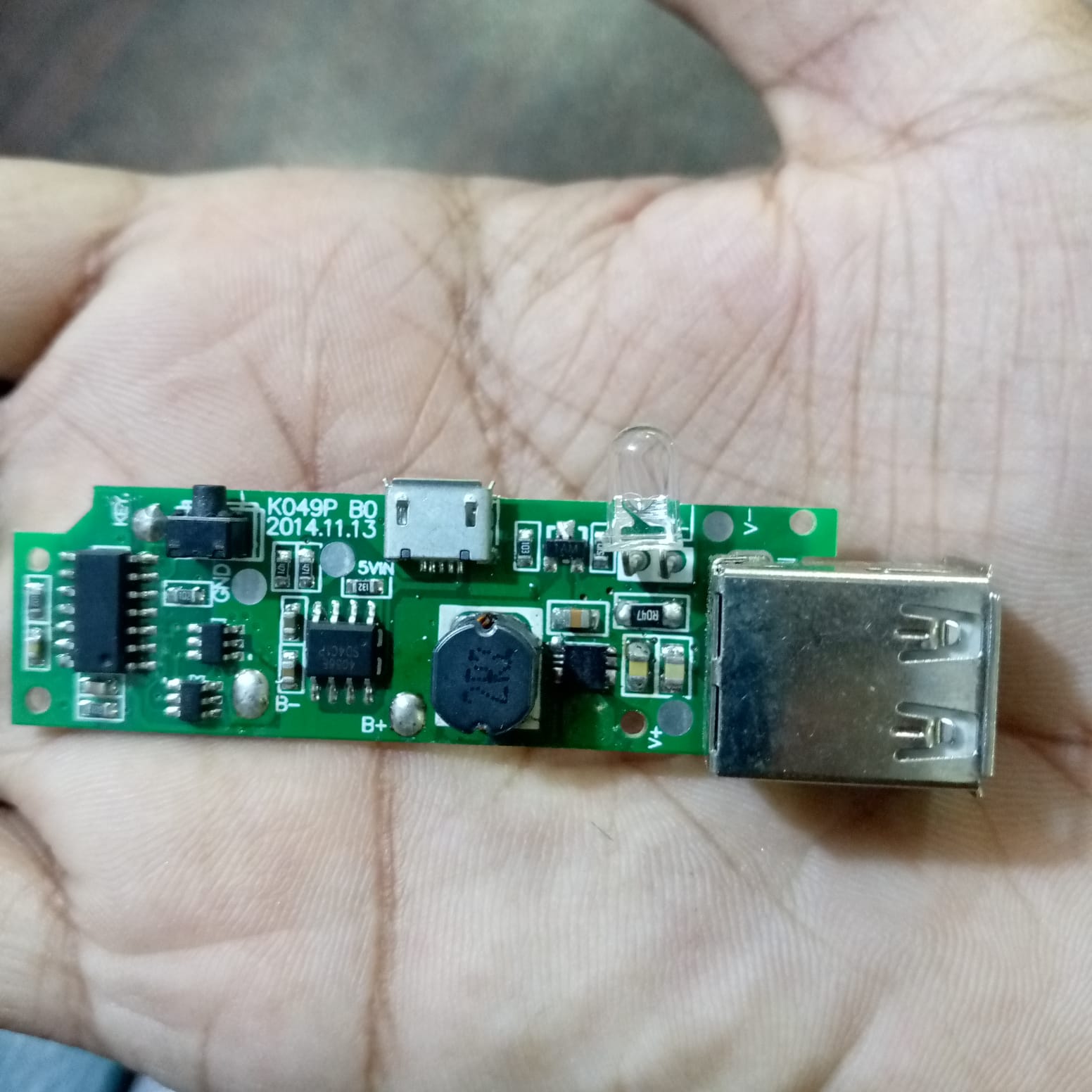 Dual USB Power Bank Module - shown as a green circuit board with a micro-USB port, a USB-A port, an LED light, and a push-button switch.