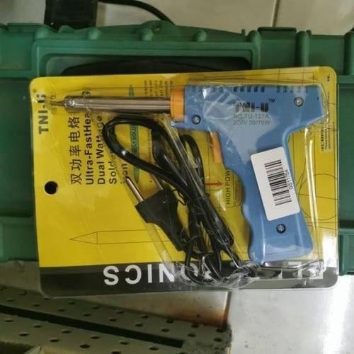 Dual Wattage Electric Temperature Gun Soldering Iron TU-127A - its original yellow and black plastic blister packaging with a power cord and plug.