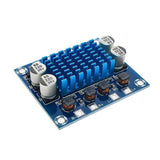 Durable TPA3110 XHA232 30W + 30W 2.0 Channel Digital Stereo Audio Power Amplifier Board - a blue circuit board with a heat sink, four capacitors, and terminals.