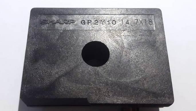Dust Sensor Module GP2Y1010AU0F Compact Optical Dust Sensor - shown as a close-up of the black rectangular housing with the Sharp GP2Y10 14 7X18 text and central circular hole.