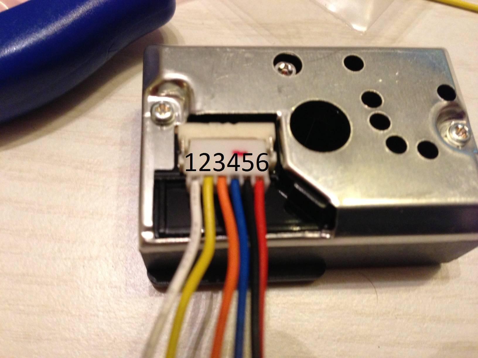 Dust Sensor Module GP2Y1010AU0F Compact Optical Dust Sensor - a close-up of the metallic sensor housing with a six-pin white connector and attached multi-coloured wiring harness.
