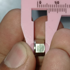 Eccentric Sleeve Type A 8X6 Spacer Eccentric for structural profile under V-slot OpenBuilds 6 mm engraved - shown in a close-up being measured by a pink plastic vernier caliper.
