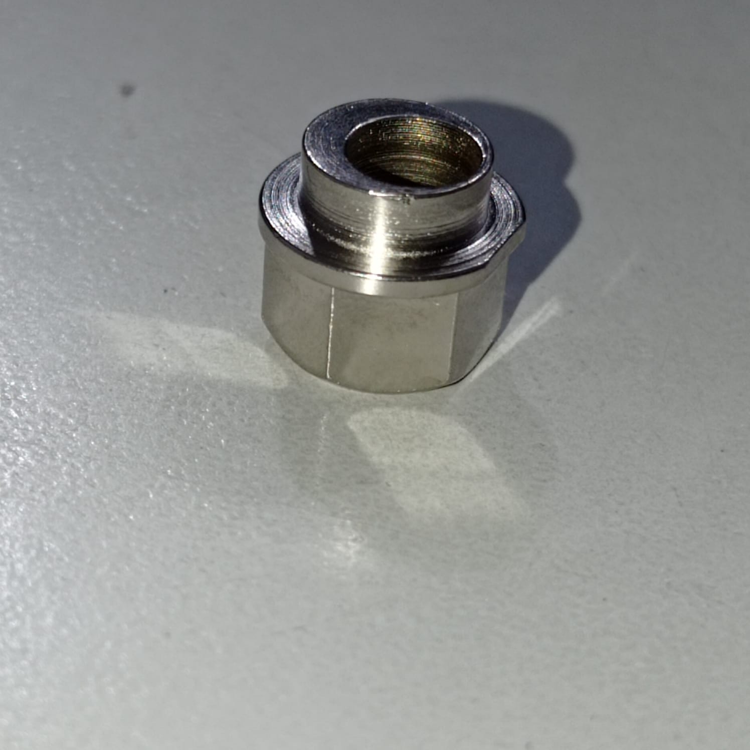Eccentric Sleeve Type A 8X6 Spacer Eccentric for structural profile under V-slot OpenBuilds 6 mm engraved - a close-up of a silver-coloured metal eccentric spacer with a hexagonal base and a cylindrical top section.