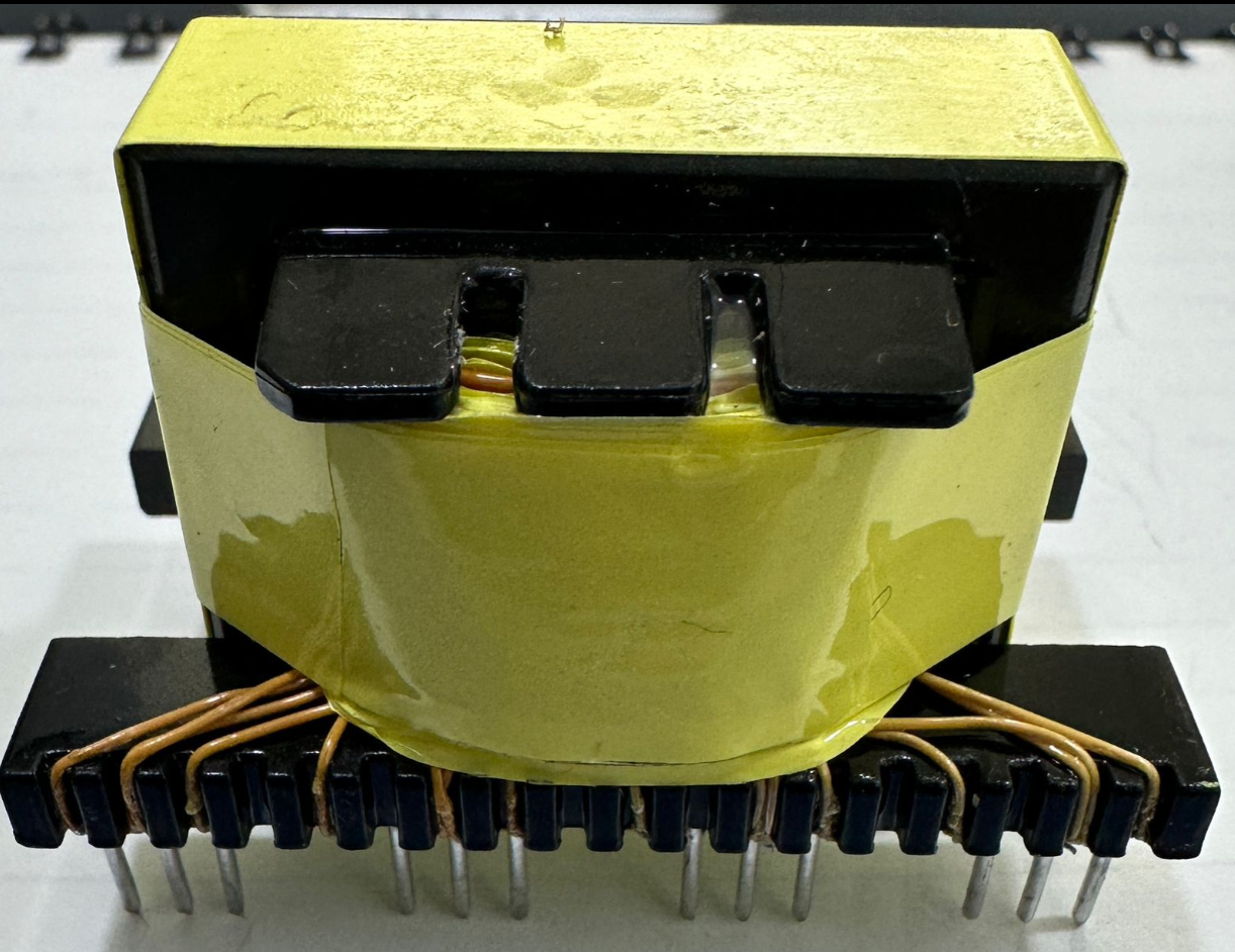 EE33-1.5-15kW Solar Inverter Transformer 23 Pins - a yellow-taped transformer core with black top and bottom frames and multiple metal pins underneath.