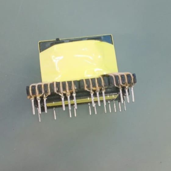 EE33-1.5-15kW Solar Inverter Transformer 23 Pins - shown as a yellow-taped electronic transformer component with multiple metal pins on a grey surface.