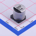 EEEFT1E102UP 1000uF 25V Capacitor SMD Type - a cylindrical silver-colored component with a black base, shown on a grid background for scale.