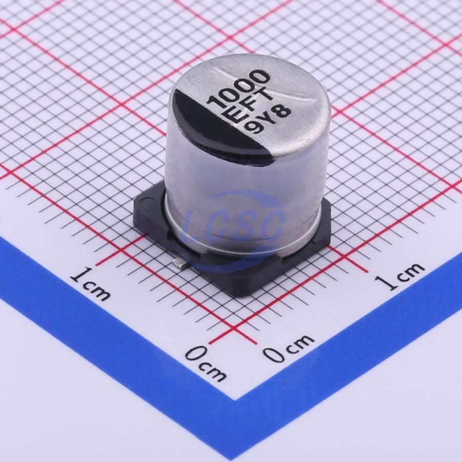 EEEFT1E102UP 1000uF 25V Capacitor SMD Type - a cylindrical silver-colored component with a black base, shown on a grid background for scale.