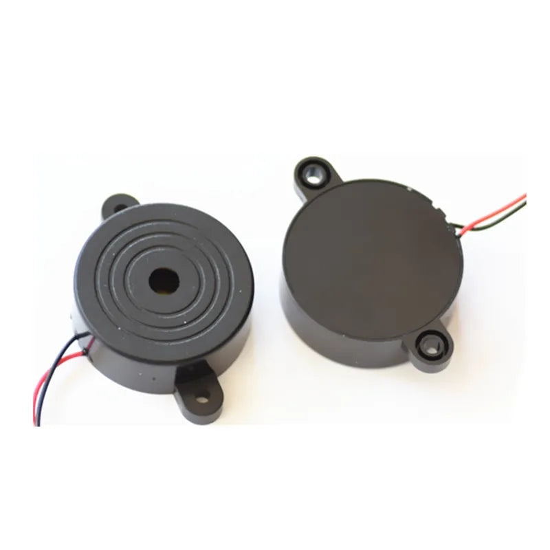 Electronic Buzzer Beep Alarm 3V To 24V - shown as two round black buzzer units with mounting tabs and attached red and black wires on a white background.