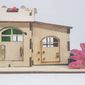 Electronics STEM DIY Home Kit House Construction Light House Model Experiment - a wooden house with two doors, a metal hinge, and a red power switch on top.