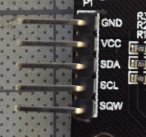 Elegoo DS1307 Module V03 - a black circuit board edge with a five-pin header labeled GND, VCC, SDA, SCL, and SQW.