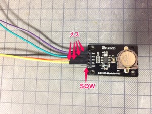 Elegoo DS1307 Module V03 - a black rectangular circuit board with a coin cell battery holder, connected to four jumper wires via female headers.