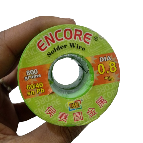 Encore Solder Wire 400 Gram 0.8mm - a close-up of a green spool of solder wire held in a hand with product specifications printed on the label.