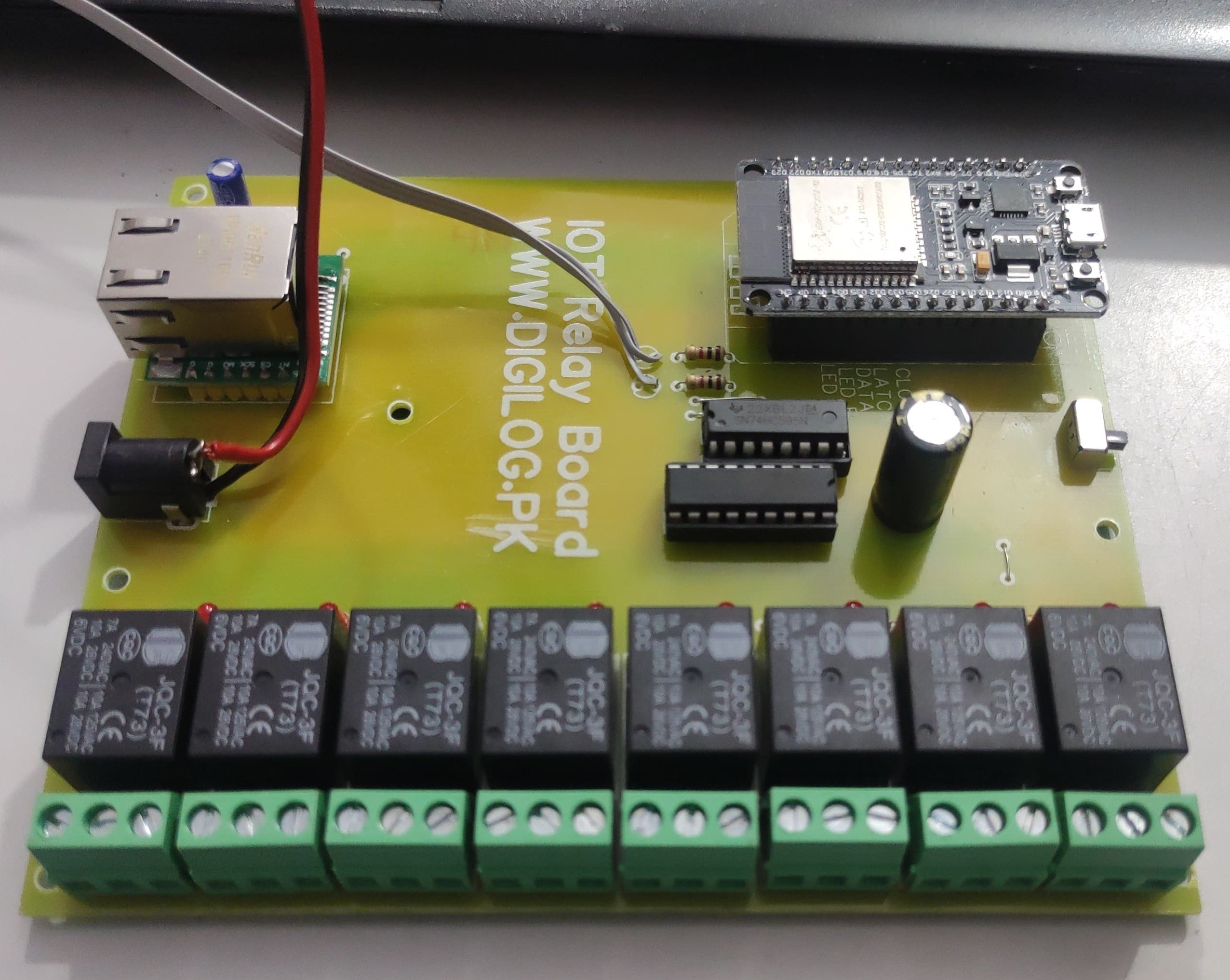 ESP32 Based 8 Channel Relay Board Micro Controller Board WiFi LAN Bluetooth - a green PCB with eight black JQC-3F relays, an ESP32 microcontroller, an RJ45 port, and a DC power jack.