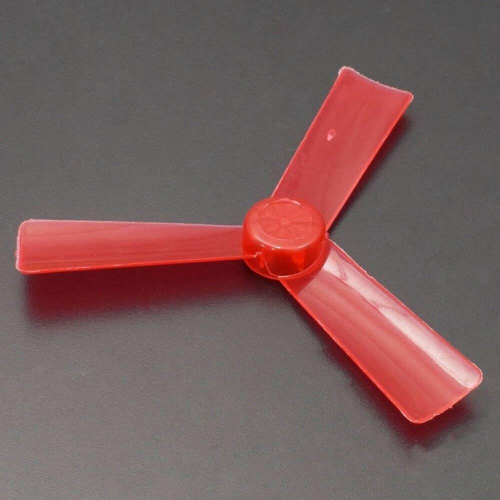 Fan Blade For Toy Motor - a three-bladed, transparent red plastic propeller shown from a top-down perspective on a dark background.