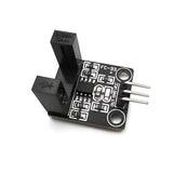 Fc-33 10mm Arduino RPM Sensor Rotational Speed Measuring Sensor - a black U-shaped optical sensor module with three metal pins and two mounting holes on a printed circuit board.