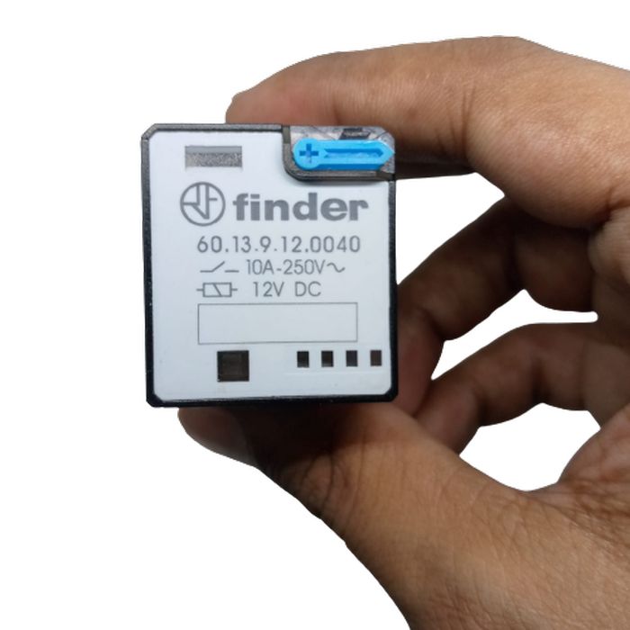 Finder Relay 12VDC 10A 60.13 With 11PIN Rail-mount Relay Socket Relay Base - 60.13.9.12.0040, a black rectangular relay held by a hand, showing a blue manual test button and technical specifications printed on the front.