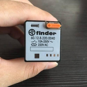 Finder Relay 220VAC 60.12 With 8pin Rail-mount Relay Socket Relay Base - a rectangular black and white electronic relay held in a hand, featuring an orange manual test button and printed specifications.