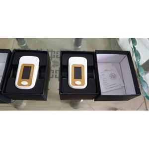 Finger Pulse Digital Oximeter-SPO2 - shown in two open black boxes, each featuring a white and gold device with a screen and a single circular button.