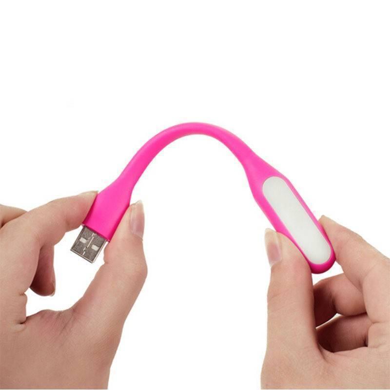 Flexible Mini USB LED Light - shown in pink, featuring a flexible body, a white light panel, and a USB-A connector held between two hands.