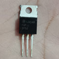 FQP3P50 -500V -2.7A P-Channel Power MOSFET - a black electronic component with three metal pins and a mounting hole, shown in a close-up against a skin background.