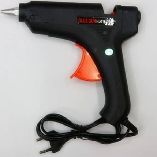 Glue Gun For 11mm Glue Sticks 80W 50/60Hz - a black handheld glue gun with an orange trigger and an attached power cord with a two-pin plug.
