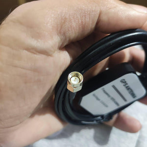 GPS Antenna External Active Antenna For GPS – 3-5V 28DB - a close-up of the gold-coloured SMA connector and the black antenna housing with a white label.