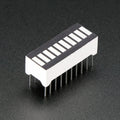 Green 10 Segment Light Bar Graph LED Display - a rectangular component with ten white rectangular light segments and twenty metal pins on the bottom.