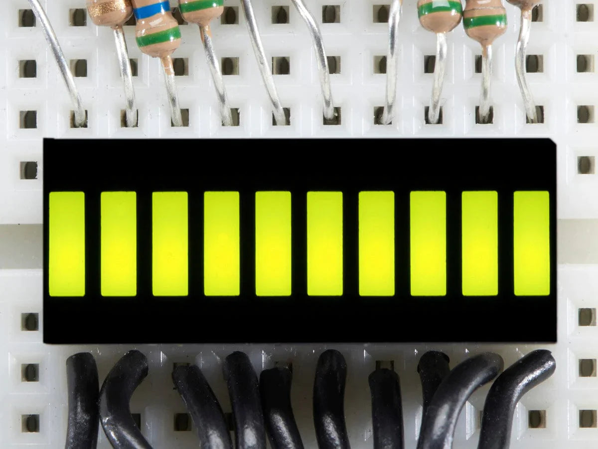 Green 10 Segment Light Bar Graph LED Display - ten illuminated yellow-green rectangular segments mounted on a white breadboard with wires.