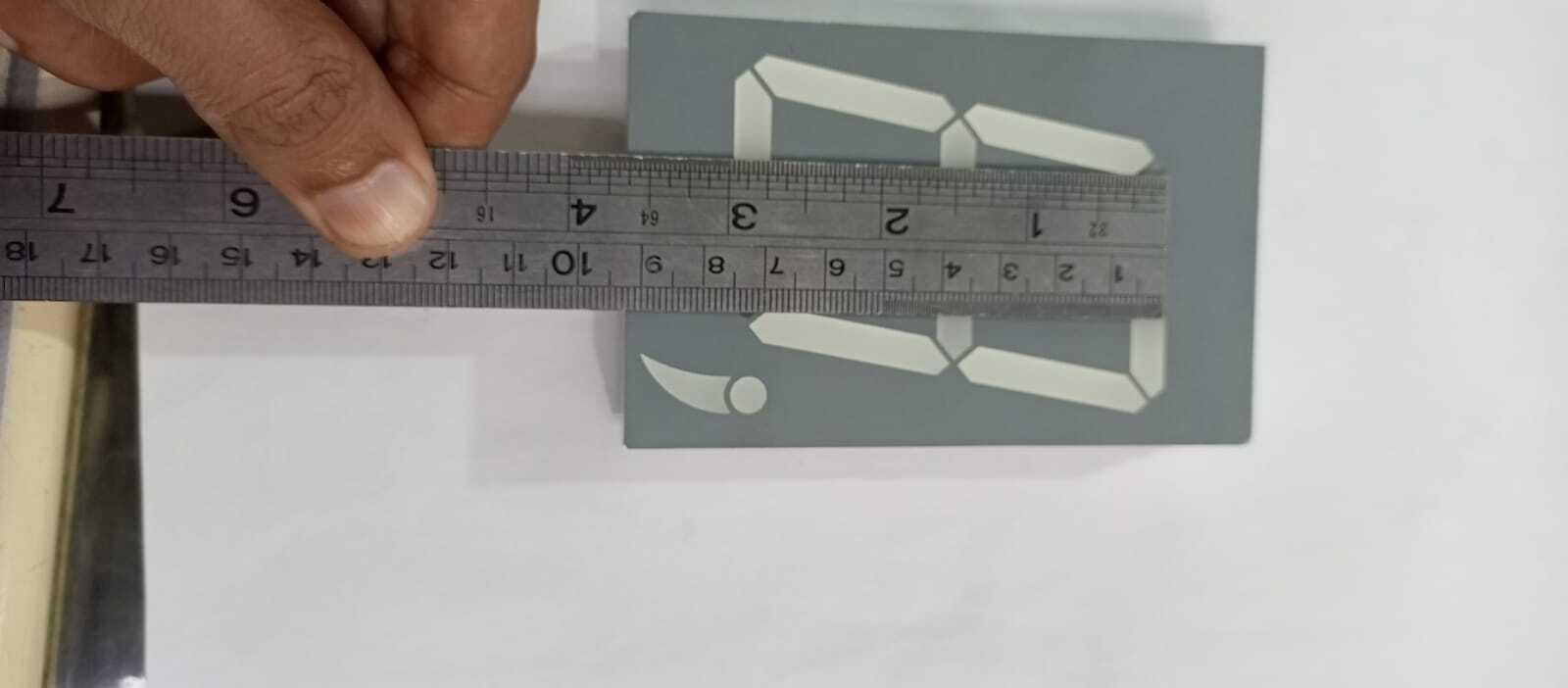 Green color 7 segment - shown from a top-down view with a metal ruler placed across its width to indicate its physical dimensions.