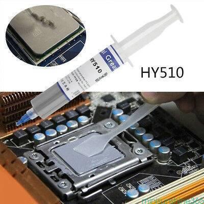 Grey White Heat Sink Thermal Grease Paste HY510-TU20 For CPU VGA LED Chip Set - shown as a grey substance in a syringe and being spread with a plastic spatula onto a CPU mounted on a motherboard.