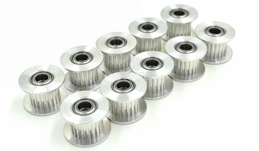 Gt-2 Idler Pulley Series 20T 10mm Belt Size 5mm Bore With Teeth - a group of ten silver-colored metal toothed pulleys with central ball bearings arranged on a white surface.
