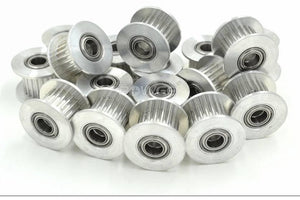 Gt-2 Idler Pulley Series 20T 10mm Belt Size 5mm Bore With Teeth - a pile of silver aluminum toothed pulleys with integrated ball bearings.